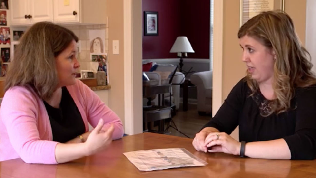 A parent and a expert talking at a table